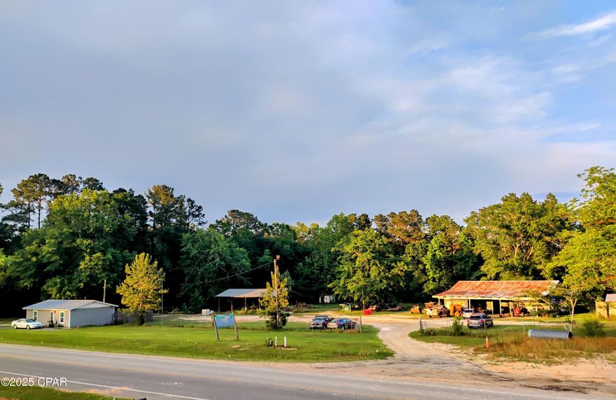 Check out this income producing opportunity with high visibility and approximately 384' frontage on a busy highway in Washington County, Florida. Highway 77 is currently undergoing an expansion project from 1 mile north of Wausau south to Highway 20. This section of Washington County is rapidly expanding, with many new homes under construction and many slated to be built in neighboring communities. Other large construction projects are in the works as well. As of the date of this listing, Florida DOT's website claims that the 2023 AADT traffic count is 5,300. Easy access north to I-10 or south towards the beautiful beaches of the Emerald Coast. Parcel includes 3 acres of commercial land, an approximately 864 square foot renovated block building that currently serves as a 1 bedroom 1 bathroom rental house, a 3,000 + square foot 3 bay garage with an office, two 11,000 pound capacity 2 post lifts, an industrial air compressor, and a bathroom, as well as an approximately 50 ' x 25' pole barn. There's plenty of room to add on, build more structures, or use the existing structures for your own business. So many possibilities; you could live in the small house and rent the shop, turn the shop into a farmer's market, or turn the small house into a boutique just to mention a few. Ask about other available adjacent parcels.