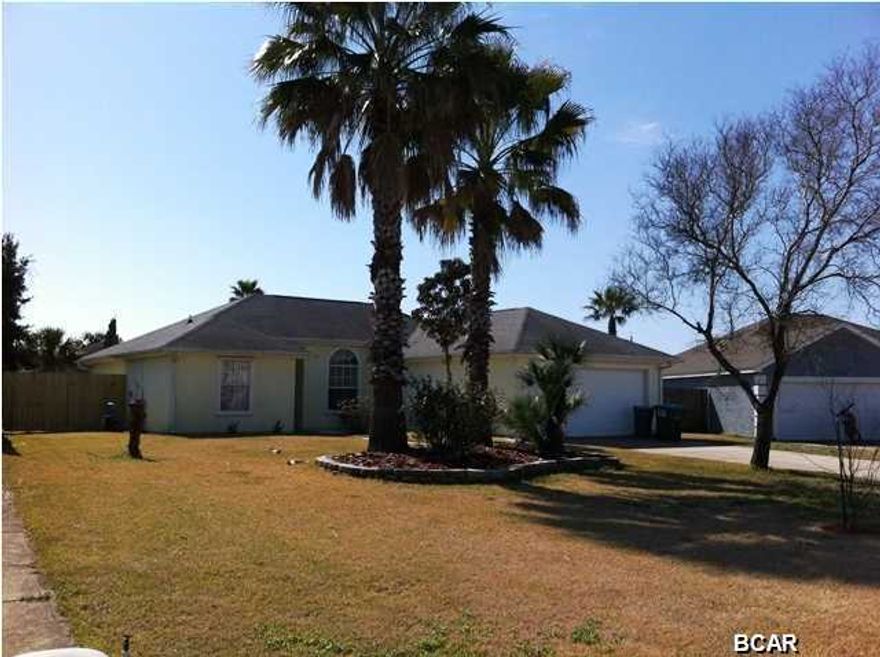 Here's your beach house!! Walk to the beach (just a few blocks)!! Great location in the heart of Panama City Beach! A 5 minute drive to Pier Park! Adorable 3 bedroom, 2 bath home with a split floor plan. This well-kept home is on a cul de sac and has a nicely landscaped yard, zoysia grass. The spacious back yard has a privacy fence and there's a large screened in porch that's all tiled! The flooring throughout the home is laminate except in the bedrooms, which are carpeted. The living room, kitchen and dining room are all open. The kitchen has a beautiful decorative backsplash and breakfast bar. The architectural details and Tiffany styled light fixtures add to the charm!The laundry room is off the kitchen. The spacious master bedroom has a bathroom en suite and huge walk in closet.