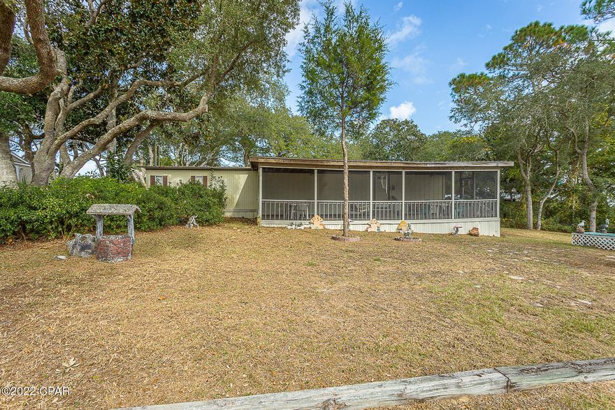 Currently under contract, seller will consider backup offers. Your personal retreat! Located in historic Lanark Beach, relax on your front porch with views of St. George Sound and the Gulf of Mexico. You will find everything you need, as this 2/2 home with addition commands two lots which also host two garages, one with a heated and cooled workshop, a potting shed and greenhouse, and best of all, a freestanding additional kitchen in the backyard, perfect for cooking up a day's catch of fresh seafood. This fully furnished coastal retreat is accepting cash offers only and won't last long.



All info is believed to be accurate but should be verified if important. Text, call, or email today for your personal showing while it's still available