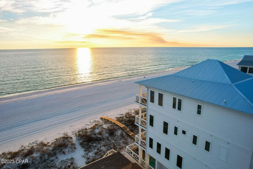 Featured on HGTV this stunning luxury beachfront home is located on the sugary white sands of the Gulf of Mexico in Panama City Beach. This newer constructed 5 bedroom, 5.5 bath duplex comes fully furnished and can sleep up to 19 guests making it an excellent investment property. As you enter the 1st level you will find a spacious bunk room with full bathroom in the hall. Stop by the wet bar to grab a cocktail on your way out to the private heated pool with direct beach access from the beach walkover. The second floor seamlessly blends living and dining areas creating the perfect space for entertaining. The gourmet kitchen features custom cabinetry, premium stainless-steel appliances, tile backsplash and beautiful quartz countertops. Enjoy panoramic views of the Gulf of Mexico from the balcony off the living room. The third floor has two guest bedrooms, each has an ensuite bathroom with custom cabinetry, quartz countertops, and designer tile with frameless shower doors. The fourth floor has a spacious guest bedroom that has custom-built queen over king size bunk beds. The ensuite bathroom is complete with double vanity, quartz countertops, frameless shower stall, and designer lighting and mirrors. The oversized primary bedroom has its own private balcony with unobstructed views of the beach to the East and the West. The master bath comes complete with a walk-in shower, freestanding soaking tub, quartz countertop with dual vanity, and custom cabinets. Additional features in this gorgeous home include hurricane impact windows and doors, built elevator-ready, upgraded lighting fixtures and pendants, tankless hot water heaters, and each floor has a deck that provides spectacular views of the beach.