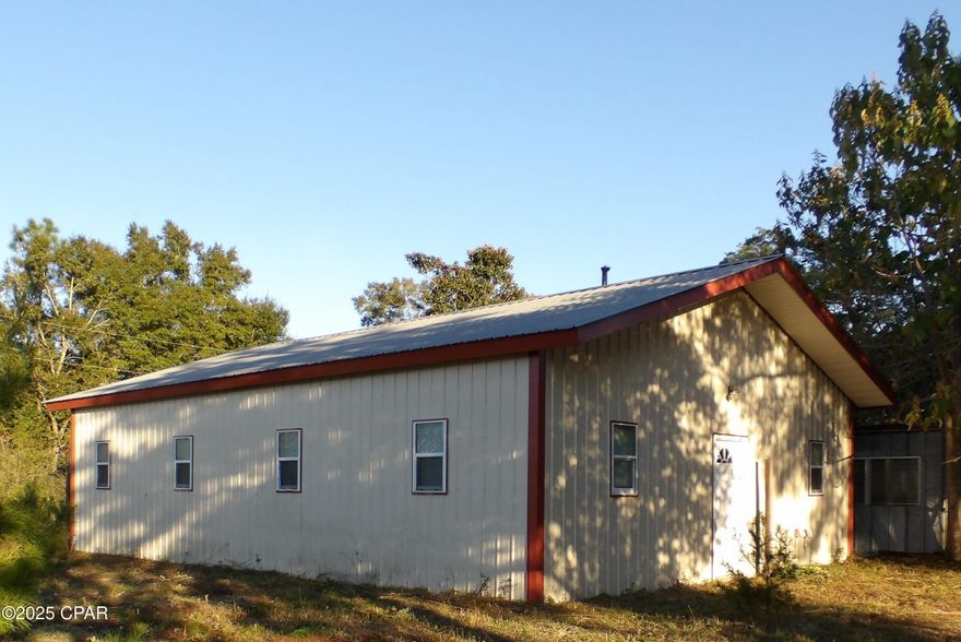 Reduced!! Many opportunities available for this 4.75 acre parcel with on 430 feet of Highway 77 frontage.  The property has a number of improvements on it.  The main structure is a 1200 square foot, 40x30 metal building that has a 10 by 8 shed converted to a half bathroom behind it that was used as a store..  There is also a 432 square foot building used as an efficiency that has a loft.  Three other storage sheds on the property that are 20x16, 16 by 25 and 16 by 20.  The is also a a 12 x 48 carport pole barn.  The property also has a shooting range on it.  Electricity and plumbing run along the south side of the property.  Seller motivated and ready to move on, take  a look and make an offer today. Offered as is.  All sizes are approximate or taken from other sources please verify accordingly.