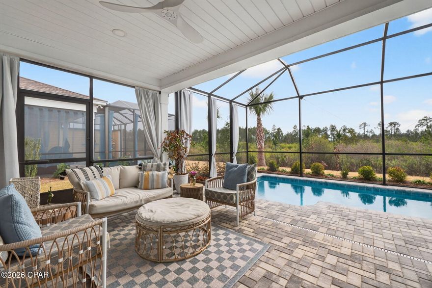 Welcome to your slice of paradise in Latitude Margaritaville at Watersound!
This beautifully upgraded Tortola villa is ideally situated on a quiet cul-de-sac preserve lot, offering exceptional privacy and breathtaking sunset views from your screened pool and lanai. Just 7 miles from the stunning white-sand beaches and emerald waters of the Gulf Coast, this home perfectly blends coastal living with resort-style amenities.
Residents of Latitude Margaritaville at Watersound enjoy resort-style living with a state-of-the-art fitness center, pickleball and tennis courts, a lagoon-style pool, on-site dining, live entertainment, and a full calendar of social activities! HOA includes all landscaping and use of the amenities giving you a truly carefree lifestyle.
The popular Tortola floor plan is the only villa design in the community offering 2½ baths — a rare and highly desirable feature for hosting guests. Inside, you'll find an open-concept layout filled with natural light and enhanced by thoughtful upgrades throughout.
The kitchen is both stylish and functional, featuring white cabinetry, quartz countertops, stainless steel appliances, a gas range, and a refrigerator included with the home. Quartz surfaces continue into all bathrooms, where you'll also find glass-enclosed showers with tile extended to the ceiling for a clean, upscale finish.

Additional upgrades include:
Upgraded ceiling fans
Extra electrical outlets under bathroom cabinets and in the flex room
Plantation shutters in the spacious guest bedroom
Hurricane shutters
Impact glass front door
Cool decking floor in garage
The versatile flex room makes an ideal home office, hobby space, or additional guest area.

Washer and dryer and a like-new Evolution golf cart are negotiable — making it easy to start enjoying the vibrant community lifestyle right away.

Relax by your private pool as you take in serene preserve views and unforgettable sunsets, or explore the incredible amenities that make Latitude Margaritaville at Watersound one of Northwest Florida's most sought-after 55+ communities.

This is coastal resort living at its finest — upgraded, private, and move-in ready.