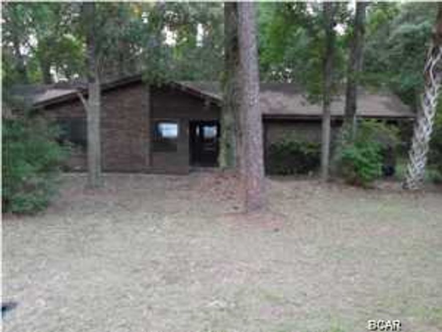 Don't miss this opportunity to own a large single story home, with 3 bedrooms and 2 baths, in the quaint city of Apalachicola. Surrounded by similar, large ranch homes, this is a great location. The interior boasts a separate living and dining area, plus a cozy den with fireplace. The master bedroom has a big walk in closet and a vanity/dressing area which leads to the master bath. The eat-in kitchen has a large dinette area and breakfast bar. Enjoy quiet afternoons or early morning coffee on the screened rear patio. (All info is approximate, buyer to verify any/all info that is important.)