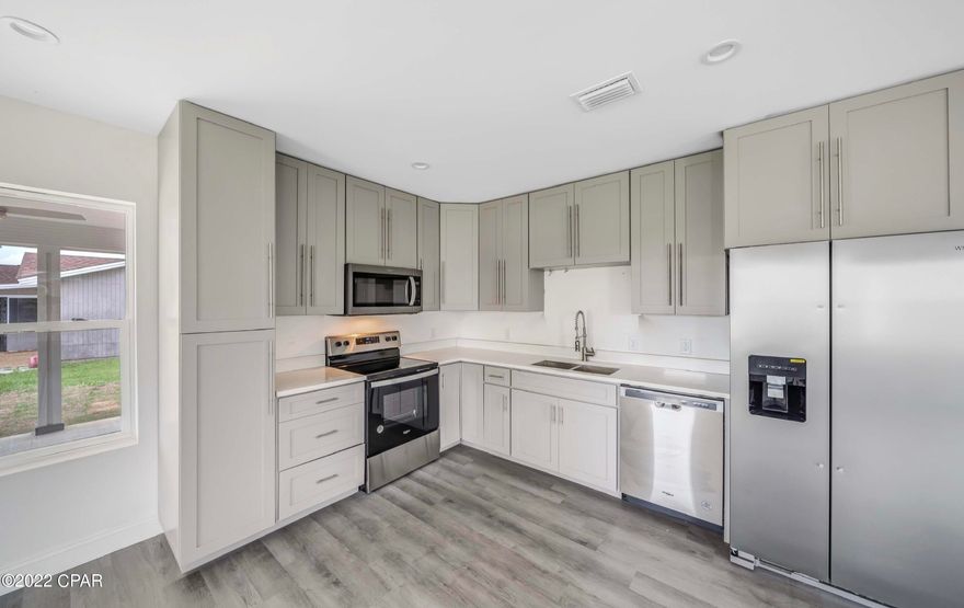 CURRENTLY UNDER CONTRACT, SELLER WILL CONSIDER BACKUP OFFERS' Be the FIRST PROUD OWNERS of NEW Construction with NO HOA on a LARGE FENCED LOT in Towne and Country Lake Estates! Sitting on one of the highest lots in this pretty community not far from Tyndall Air Force Base, this well-insulated home with BEAUTIFUL finishes includes STAINLESS appliances, refrigerator with ice and water in the door, QUARTZ countertops, Shaker-style cabinets, and ON DEMAND, TANKLESS hot water. Other features include LVP flooring and durable tile throughout, along with recessed lighting and trendy ceiling fans in all 3 bedrooms. Closets include CUSTOM shelving. The FENCE has DOUBLE GATED ENTRY access and AMPLE SPACE for RV and Boat parking in your HUGE yard. Clad in HARDIE-brand siding to include the facia, the