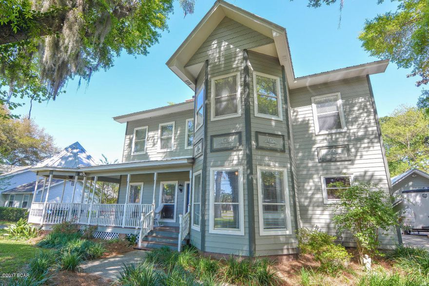 This College Point beauty has it all! Large home that has tons of space to entertain. Remodeled kitchen is a chef’s dream with 2 kitchen spaces, 2 dining spaces, maple cabinets and stainless steel appliances. 10' ceilings coupled with solid 3/4'' hardwood flooring and amazing 12'' baseboards add to the stunning beauty of this home. Warm yourself by the wood burning fireplace in your family room, or enjoy the natural beauty from the comfort of your Florida room. Your master suite and updated master bath offers a double vanity, large walk in closets and office nook just off master. Large additional bedrooms, extensive crown molding, wrap-around porch and gazebo with a charming swing, large backyard with deck, tons of shade, new metal roof in 2010 and detached two car garage for the handyman in your life. This home is a MUST see.