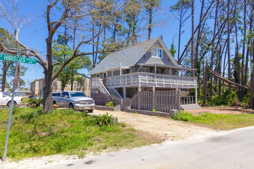 BRAND NEW ROOF! Built Strong!! 1.2 mile to Navy Base & 1.9 miles to beautiful white sugar sand beaches! Privacy & space to enjoy entertaining everywhere! Features an over-sized deck that wraps around the open concept style kitchen and living area. The downstairs patio has a built-in fire pit & GREAT space for a big party. Double car garage and sits on a great corner lot so there is a huge area along side of home to park all your toys! A separate yard for whatever you want is fenced on the northside of property. This totally remodeled home has 3 bedrooms & 2 full baths w/ a huge room on the ground floor that would be great for either a mother in law suite or a Man Cave PLUS a bonus room for an office or playroom! Most pictures are pre-hurricane, but home is still in great shape!