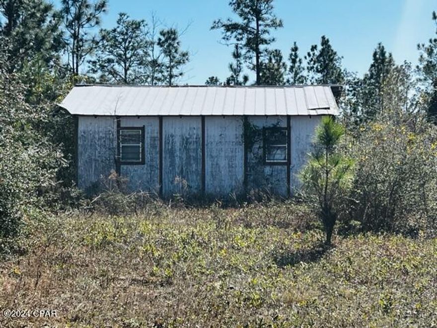 Investor Special! This furnished fixer-upper cabin sits on three parcels totaling almost 2 acres and offers endless potential. Located just over a mile from the North Florida Motorplex, it's perfect for racing enthusiasts or savvy investors looking to capitalize on the area's drag racing and dirt track entertainment. The property includes a well and electric hookup, but a new septic system is needed as the previous one was shared. While the property was previously surveyed, the seller no longer has a copy.  Contact your realtor for a showing!