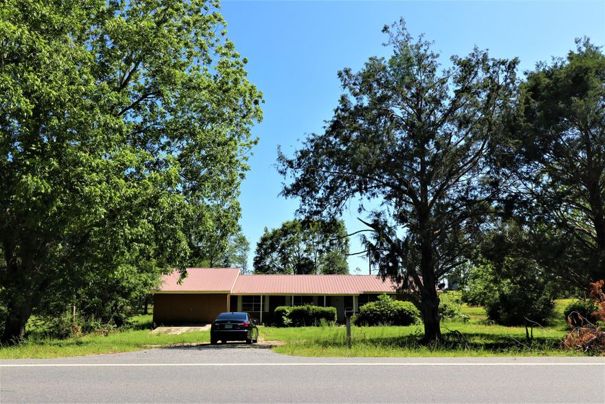 Country Lot, 1 acre,  with brick home ready for your touches to make it a home again.  This home features open living,dining, kitchen area with 3 bedroom and a full bath located to the right side of home. To the left of the living/dining area there are 3 more rooms, 2 with closets and one on the rear of home with a door to back yard-this room could make for good storage space.  The rooms to the left come from the garage area being enclosed and is not included in the property appraisers square footage noted in this listing.  All together you are looking at approximately 2000 sq ft of inside living space. All measurements and information should be verified by buyer or agent if important. Thank you for considering this property!