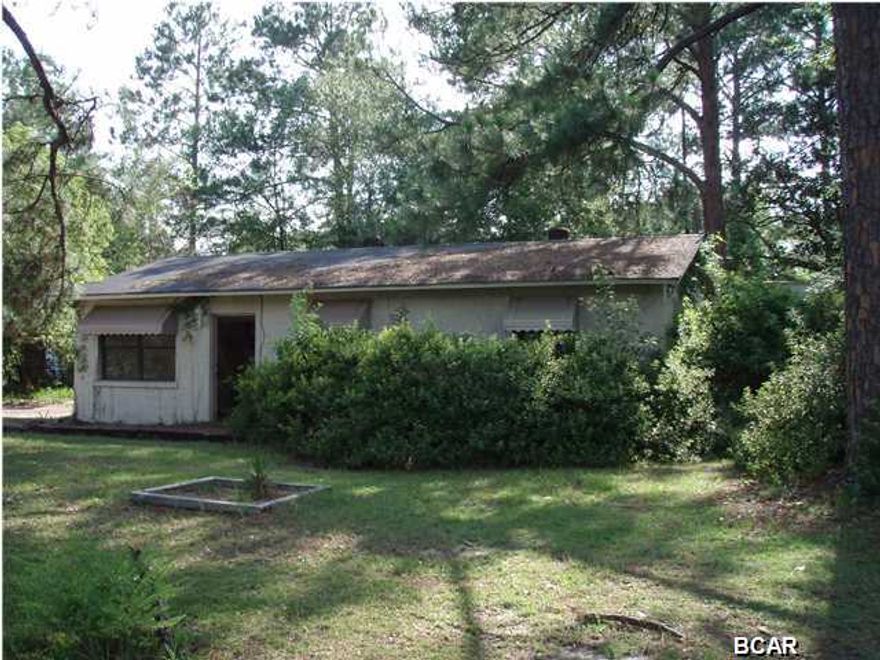 Ready for your next project? Half acre corner lot on 390 in Lynn Haven with large 20x22 workshop. This 2 bedroom 2 bath home has an open floor plan with a screened back patio and privacy fenced backyard. Large master bath with all wood panels and full size jacuzzi. Home needs work likely to include ceiling repair, appliances, flooring, paint, and exterior wood repair. Home was built before 1978 and there is a possibility of lead based paint.