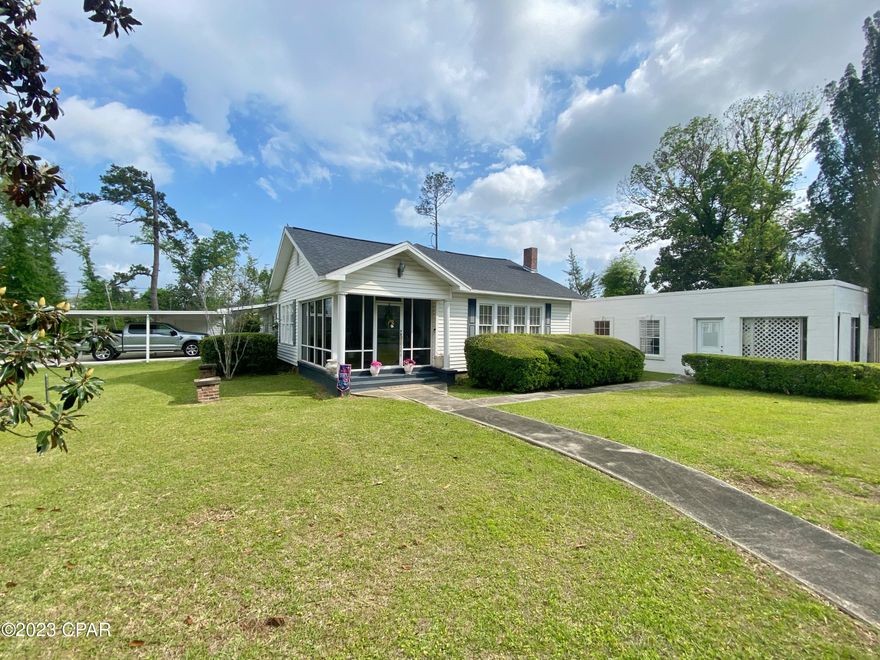 PROPERTY UNDER CONTRACT; OWNER WILL CONSIDER BACKUP OFFERS. You will fall in love with this beautiful 1930s era home!  The home has original hardwood floors throughout, and boasts 2 living areas both with electric log fireplaces. Both living rooms open to outdoor living spaces- one to a cozy tiled sunroom with lots of natural light, and the other to a deck that is perfect for grilling and enjoying the fully privacy fenced backyard.  This lot is quite large for a city lot- 1/2 acre in size; perfect for pets or children. This home is well maintained & has had updates such as a Rinnai instant gas water heater, carport added, and a newer roof and hvac (only 5 years old). There is also added attic storage with full staircase to it & an outdoor shop.