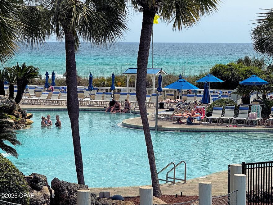 Discover the ideal family beach getaway in this low second-floor condo, perfectly designed for families with children. Overlooking the grand lagoon pool and splash pad, your kids will love the easy access to fun water features and the nearby beaches of the Gulf. The condo is just steps from the game room and onsite market serving ice cream--making every day an adventure for the little ones. Enjoy a private balcony with stunning pool and beach views, a spacious living room for family gatherings, and an owner's suite with resort views and a luxurious bathroom. The full kitchen with breakfast bar and dining area is perfect for family meals, while the guest room features two full beds just for the kids and convenient access to the guest bathroom. There is a tub for bubbly baths, cushy new carpet for small feet, and stylish low maintenance porcelain tile. Move-in or rental ready, this condo offers everything a family needs to create lasting memories together. Pets are part of the family so bring them along; both the dog beach and dog park are just minutes away. Being an Edgewater Beach & Golf Resort owner brings exclusive access to beaches, pools, hot tubs, restaurant, market, pickleball, tennis, fitness center, golf+pro shop, kids splash pad, game room--all within a fenced, beautifully maintained property. This property is safe and secure with manned, gated entrances, roving security, and lighting throughout. Convenient building-side parking, vehicle charging, and parking for RVs, boats, jet skis, trailers is readily available. Edgewater Find the beach lifestyle you've always dreamed of living!