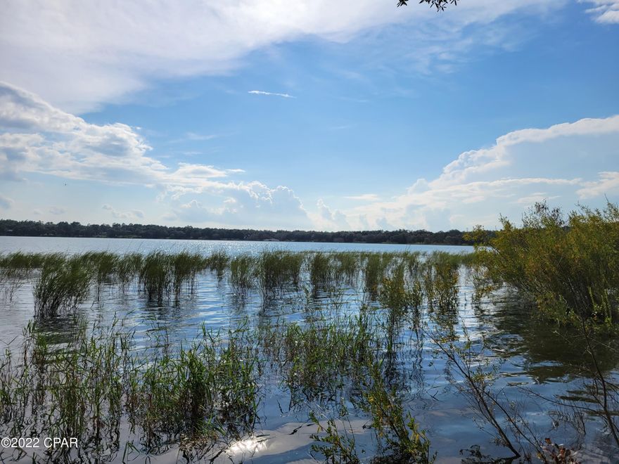 Watching the sun go down over a clear, clean lake will never get old. This 1 acre lot is located on the east side of the large lake in Leisure Lakes and affords a stunning sunset every evening. The lake is great for swimming, boating, kayaking, fishing or floating on a raft. It is about 3 miles around this large lake and would be a wonderful homestead or weekend getaway for your family members. It would be great for entertain all year round. Residents can build a dock that extends 30 feet from shore to park your boats and kayaks. Many residents fish from their dock.  Subdivision amenities include a basketball court, tennis court, toddler playground, grill stations, horseshoe pits and more. It is not far from the World's Most Beautiful Beaches or the airport. Come discover paradise!