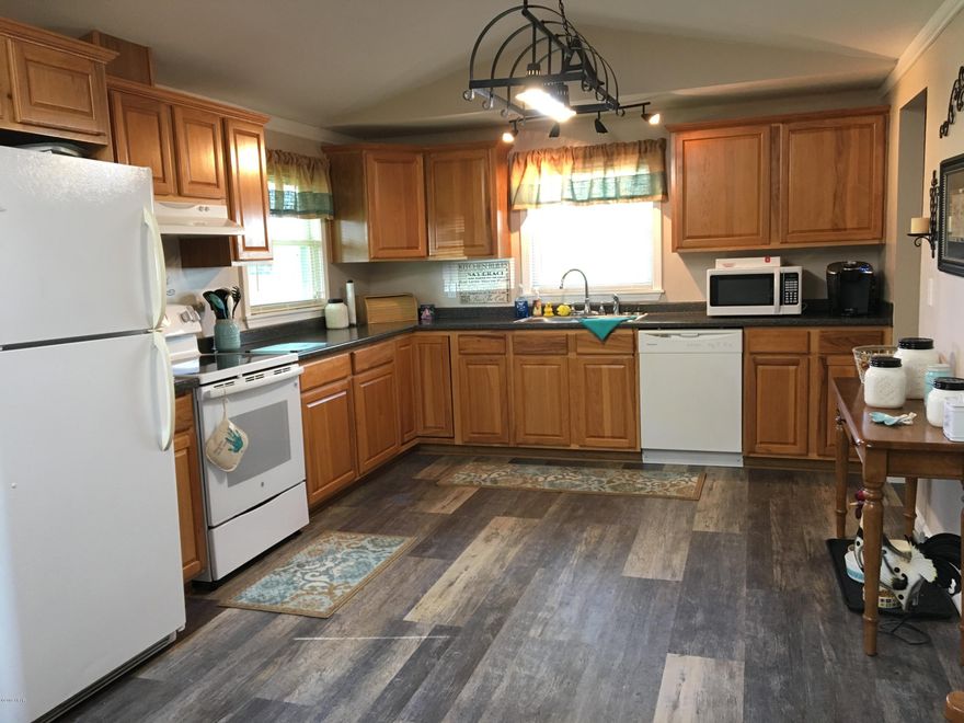 Meticulously maintained 3 bed 2 bath home located on 1/3 Acre lot in a great location! Home had minimal hurricane damages & has a brand new roof! Huge kitchen with attached large dining are offer plenty of room for entertaining. Kitchen features lovely oak cabinetry & ALL Appliances include & large walk in pantry! Living room is cozy & has new carpet. The Master Suite is spacious, has a sitting area, walk in closet & private master bath. Additional rooms are spacious & there is a 201 sq ft Florida room with ceramic tile floor & beautiful surrounding windows Not included in the 1426 sq ft & an 86 sq ft laundry room not included in the sq ft. These 2 spaces would need window units/ the 1426 sq ft has Central Heat & Air.