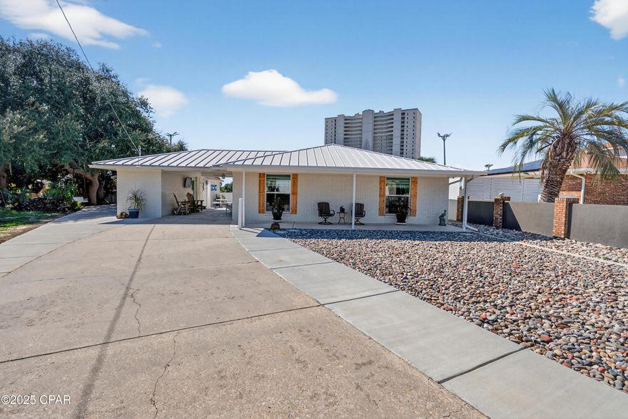 Coastal comfort features! This well-kept beachside home offers a new air conditioner, inviting front porch, and private back patio with a firepit and outdoor shower—awesome for unwinding after a day at the beach. Includes a covered carport and detached 12x24 garage for extra storage or workspace. Located in Open Sands, just minutes from Pier Park, local restaurants, Walmart, Home Depot, and Lowe's. No HOA makes this a great investment and relaxing retreat.