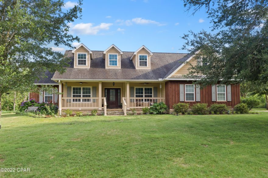 Nestled on 40+/- acres this 4-bedroom, 2 bath craftsman style home is picture perfect from top to bottom! Enter the foyer and you are immediately greeted with 18 ft ceilings, engineered hardwood floors, formal dining room, an open floor plan boasting a gourmet kitchen with custom cabinetry, breakfast bar, pantry, stainless-steel appliances and a spacious living room with wood burning fireplace. The split floor plan provides plenty of privacy for the master suite that features his/her sinks, jetted tub, separate tiled shower and walk-in closet. Enjoy your days outdoors sipping coffee from your screened in back porch, grilling under your pergola, tinkering in your 37x37 workshop with half bath and generator, racing rc cars on the custom track or riding trails on your dirt bike. Other outside features include attached 2 car garage, covered front porch and pond. This secluded find is located just minutes from Hwy 79 and a short drive to Interstate 10.