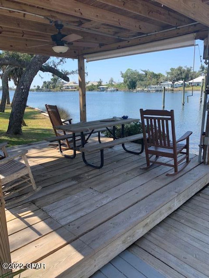 BOATERS MUST SEE!! This condo comes with an assigned DEEP WATER Boat slip that can accommodate a 40ft boat.  What a hidden gem! This 1 bedroom 1.5 bath 2 story condo located on Parker Bayou is the perfect place to relax and enjoy waterfront living. The dock is equipped with power and water. This is a quiet, small community with only 6 owners. There are 4 owners in 1 building and 2 owners in a second building. Enjoy the kayaks or the gazebo or the outdoor deck with the BBQ Grill. This condo conveys furnished. Two NEW Daikin mini-split wall units for heating & cooling. There is lovely sunroom off the bedroom to enjoy the water views and your morning coffee. The seawall has been recently redone. This condo is ready for you and your boat! Come enjoy waterfront living at Mariner's Cove