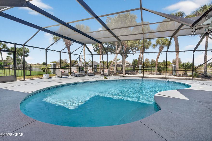 Enjoy privacy, golf course views, and resort-style outdoor living in this beautifully updated 5BR/4BA Panama City Beach home on the Nicklaus Golf Course in the gated Bay Point community. Overlooking two ponds on holes #10 and #11, the home combines sweeping golf and water views with exceptional privacy and seclusion from surrounding properties.

Designed for everyday comfort and effortless entertaining, the home features spacious living areas that flow seamlessly to the outdoor space. Step outside to your private pool and expanded patio with a covered lanai, surrounded by lush landscaping and a new Zoysia lawn - perfect for family time, hosting friends, or relaxing after a round of golf.

Inside, hardwood and wood-look tile flooring runs throughout, complemented by chair rails and crown molding. The kitchen is both stylish and functional, featuring quartz countertops, stainless steel appliances, a gas cooktop, and double ovens. This five-bedroom floor plan provides versatile spaces to meet your needs: two rooms are currently used as a study and a wine room, both easily convertible into guest bedrooms, a home office or entertaining areas.  An upstairs guest suite offers a private retreat for guests or extended family.

Convenience and functionality are thoughtfully handled throughout the home, including a renovated laundry room, a three-car garage with built-in cabinetry and additional storage, and updated systems including three HVAC units (changed within the past year), a new hot water heater (Dec 2025), refrigerator (Oct 2025), and dishwasher (under two years). Solar panels on the roof provide energy savings and help reduce monthly utility costs. Additional improvements include renovated bathrooms, refreshed interior paint (2025), air duct cleaning (Oct 2025), a new front entry door and tile, and a 2024 irrigation system - providing a move-in ready experience with peace of mind.

Bay Point is an exclusive 24/7 security-patrolled gated community which boasts a Nicklaus Golf Course, the Point South Marina with gulf access, dining at Neon's 72, and scenic walking areas. Grocery stores, restaurants, shopping, and everyday conveniences are just minutes away, while the white-sand beaches and natural beauty of St. Andrews State Park are a short drive from home. The community's safe, family-friendly environment and ample outdoor spaces make it ideal for recreation and everyday living.

Experience the ultimate Panama City Beach lifestyle in this spacious, private Bay Point home - schedule your private showing today.