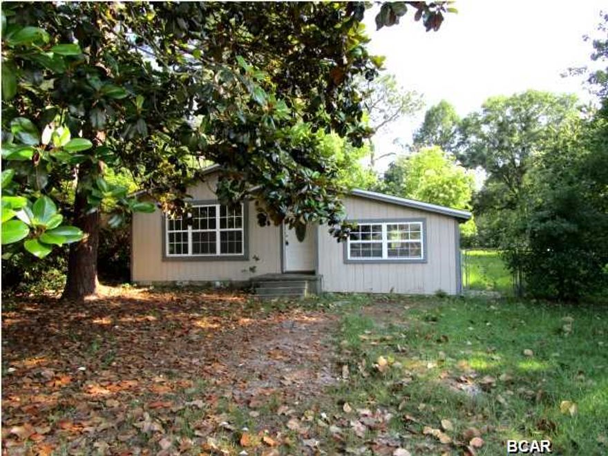 Attractive home in Lynn Haven on a large fenced lot! This home features a hardwood floors throughout the living area and all three bedrooms. The kitchen is spacious and has an eat-in dining area. From the kitchen, there is both a utility room for the washer and dryer, and there is an additional storage room attached. The backyard is fenced with a yard building. Home is being sold in its AS IS condition.