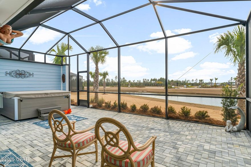 CURRENTLY UNDER CONTRACT, SELLER WILL CONSIDER BACKUP OFFERS
 Discover your dream retreat at the exquisite Tortola Villa complete with a luxurious spa that conveys overlooking a gorgeous pond view in the 55+  community of Latitude Margaritaville Watersound in Panama City Beach! This exceptional villa is unique, featuring not just two spacious bedroom suites, but also a convenient powder room and a versatile flex room, all within an expansive 1,743 sqft layout. Revel in the numerous custom upgrades that elevate this home beyond a typical new build, including stunning Luxury Vinyl Plank flooring throughout the common areas, bedrooms, and powder room, plus a stylish ocean floor epoxy finish in the garage with added shelving for convenience. Culinary enthusiasts will adore the chef's kitchen, outfitted with an upgraded stainless steel gas range, elegant quartz countertops, and a wine/beverage cooler—perfect for savoring your favorite libations while enjoying picturesque pond views. After a delightful meal, unwind on the extended pavered lanai, where you can indulge in the spa and witness breathtaking evening sunsets. Cozy up by the fireplace before retreating to the master suite, featuring a seamless shower designed for ultimate relaxation. With all this luxury at your fingertips, you're guaranteed the best night's sleep as you dream of tomorrow's adventures in Margaritaville. Whether it's soaking up live music every day, swimming in the resort-style Oasis pool, dining at Bar & Chill, or participating in countless fitness classes and events organized by the dedicated Lifestyle staff, Tortola Villa is your gateway to a vibrant and fulfilling lifestyle. Don't miss out on this extraordinary opportunity—your paradise awaits!