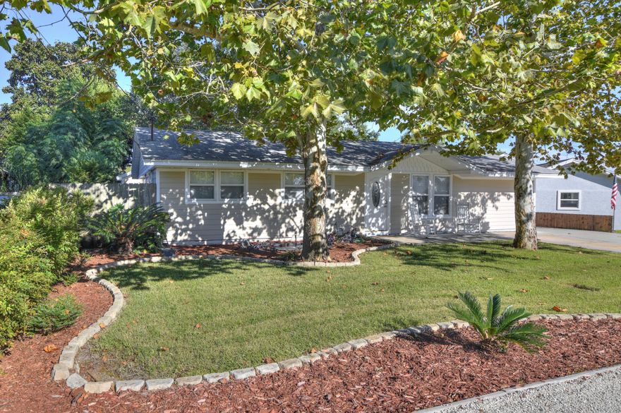 Remodeled 3 bedroom,1.5 bath home with 1,300 square feet in El Centro neighborhood. Only 2,000 feet away from public beach access and so close to Pier Park that there is a walking path to Aaron Bessant Amphitheater. The owner has remodeled and updated the house over the past five years so it's almost like buying new. Tile floor throughout, beadboard wainscotting, crown moulding, hardie board siding and trim, vinyl windows, soffits and rain gutters, AC less than 3years old, and roof is about 10 years old. The yard is awesome and guaranteed to be one of your favorite things with a big covered patio, built-in brick summer kitchen, a relaxing koi pond with waterfall, a firepit, storage shed or hobby room, a playhouse and swings for the kids and a 20x22 detached...the list goes on...