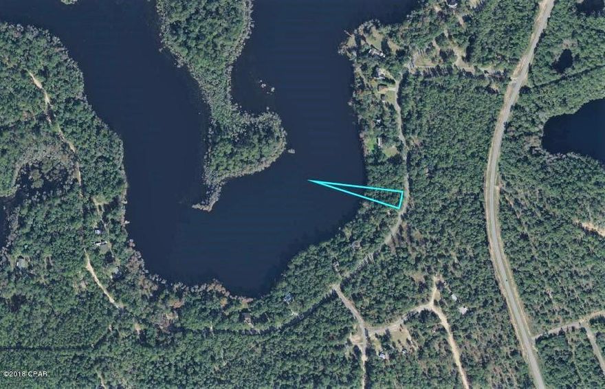 Beautiful Wooded Lakefront lot on spring fed Dunford Lake in the gated Paradise Lakes community. Build your dream home so you can enjoy the fishing and boating in this quiet community. Boats are allowed on the lake with Up to 25 HP engines and maximum 15 mph on lake. Low association fees and there is a community boat ramp within walking distance. Deed restrictions will allow minimum of 840 sq. ft. for single family dwelling and no mobile home or travel trailer living is allowed. Paradise Lakes is located in the Sand Hills area of Washington County Approx. 35 miles from Panama City Beach, and Pier Park shopping. Short drive to Chipley for shopping and restaurants. Lot next door is also for sale MLS#686603.