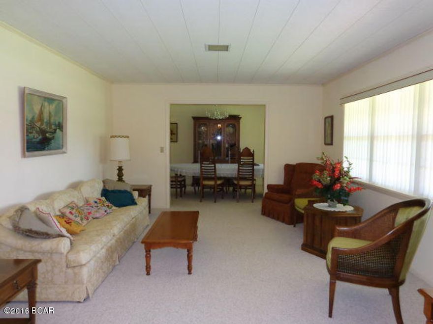 Large All Brick Family Ranch home on 7.29 acres. Plenty of elbow room. Formal Living and Dining Rooms. Renovated eat in kitchen. Quartz counter tops & tastefully refaced cabinets. Beautiful pergo wood laminate flooring (newly professionally installed in April 2015) flows from kitchen into large family room down hallway to large master bedroom suite. Family room with brick fireplace & newer french doors out to concrete patio. Plenty of storage thru out home. Walk in storage closet with shelving. Across from closet, a small office also with shelving. Linen closets, one in bathrooom & one in hallway. Master bedroom with His closets & His tiled bathroom and Her large walk in closet & Her newly installed bathroom has large walk in / wheel in tiled shower w/two shower heads. Fresh interior paint. Replaced to double insulated windows. Serviced HVAC system, newer thermostat & replaced motor. Berber carpet in formal LR/DR & additional bedrooms. Laundry room with sink & cabinet, half bath, insulated door exit out to patio, plus w&d and freezer will convey. Replaced Front door. Home does have 2 water heaters, 200 amp service, 2 septic tanks with new drain fields in 2011, gutters, crawl space, well for irrigation, plenty of room for garden, paved driveway. Fruit & pecan trees, flowering bushes & slash pines. RV port & separate Workshop w/open bays has electric & water, metal roof. Additional acreage for sale that adjoins property also located on paved road, corner location.