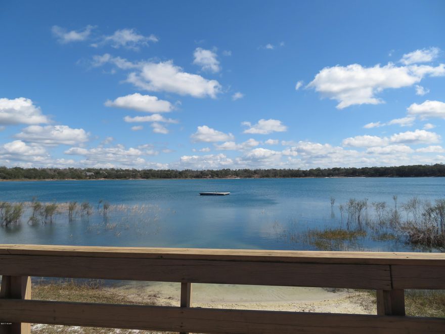 Priced to sell!! Approximately 1.04 acres of pristine Leisure Lakes waterfront on the largest of two lakes in the subdivision, enjoy beautiful views from this wonderful lakefront lot. Clear spring fed water, white sand beach, walking distance to the pool, clubhouse, tennis courts, basketball courts, boat ramp, fishing and swimming. Paved roads and natural setting as well as guard gate make this community one of the most popular in Washington County. Community has underground utilities. Boats allowed with electric motors only