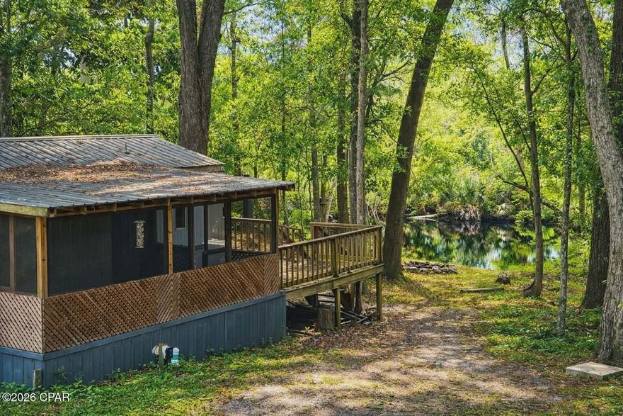 Waterfront opportunity on Black Creek!
 This 3-bedroom, 2-bathroom mobile home sits on over half an acre, offering the perfect setup for an investment property, weekend retreat, or full-time living on the water. Enjoy peaceful creek views with direct access to great fishing right from your backyard.

Located just minutes from the Choctawhatchee Bay, this property is ideal for boating, fishing, and enjoying the outdoor lifestyle. You're also less than 30 miles from Crab Island and the white sand beaches of Destin, FL--giving you quick access to shopping, dining, and entertainment.

The property features a separate electric hookup, providing an excellent opportunity for an additional camper or mobile home, adding even more income potential or space for guests.

Whether you're looking to invest or create your own waterfront getaway, this property offers endless possibilities. Schedule your showing today!

Buyer/Buyer's agent to satisfy themselves to all pertinent information regarding the property.