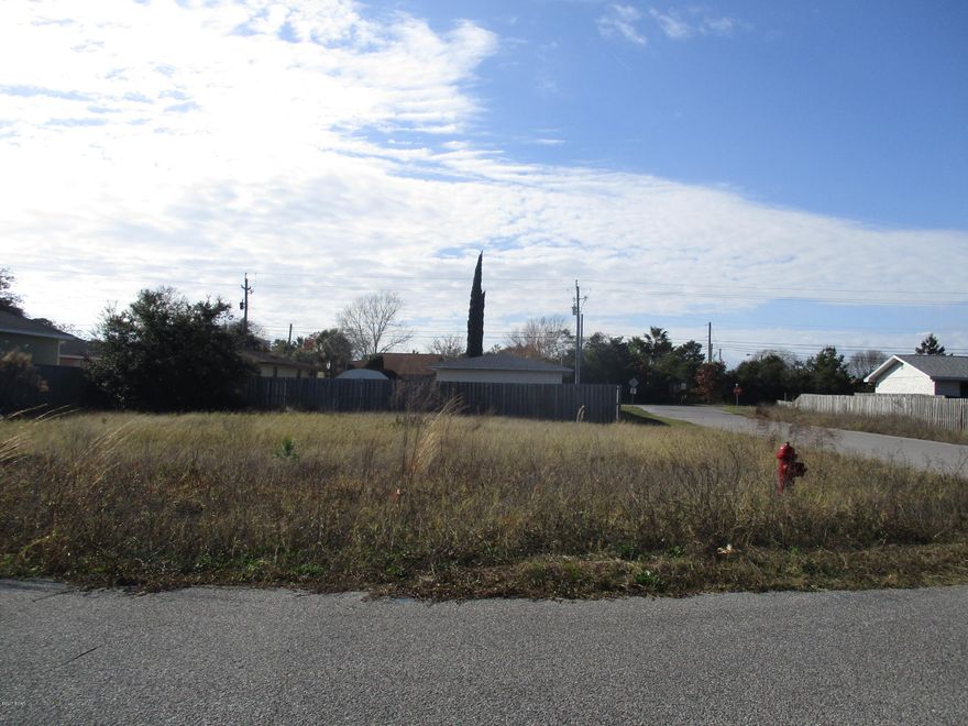 GREAT CORNER lot in Open Sands but on edge with no homes on one side or across the street. Actually is a cul de sac street and the only people driving down it would be those who live there or their guest. No thru traffic. Walkable to the beach and I would think you might be able to hear the waves from time to time. Great location to build your dream beach home!