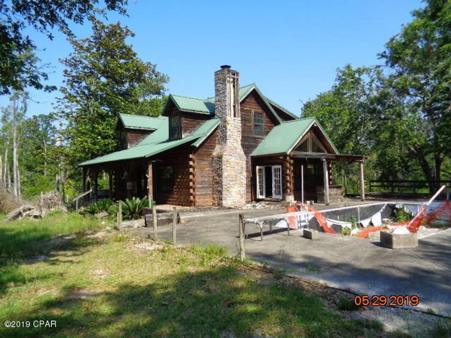 LOG CABIN SECLUDE WITH INGROUND POOL WITH LG POLE BARN..  THE HOME IS A 2 STORY HOME THAT NEEDS SOME REPAIRS. MAINLY COSMEDIC.  THERE IS AN OLD MH ON THE PROPERTY THAT WOULD NEED TO BE TORN DOWN. THIS PROPERTY STILL HAS LEGAL ISSUES WITH THE POOL ENCROACHMENT ON THE ADJOINING LAND.   iNFO FROM PROPERTY APPRAI WEBSITE PLEASE VERIFY IF IMPORTANT- CALL FOR MORE INFO