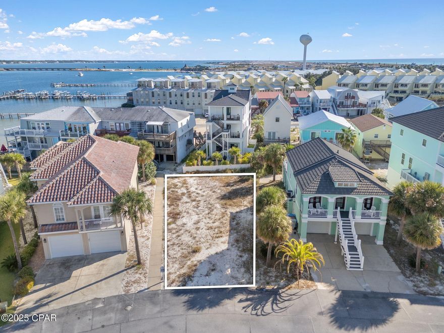 Survey Complete, GeoTech Soil Test Complete. Welcome to The Village at Navarre! One of the most sought-after communities on Navarre Beach, this private waterfront neighborhood offers the perfect blend of coastal charm and convenience. Ideally located on the Sound Side, you're just a short walk from the sugary white sands of the Gulf of America and moments from local dining, shopping, and beachside events. The Village at Navarre has no rental restrictions, making it ideal for a full-time residence, vacation getaway, or high-performing short-term rental. Community amenities include a sparkling pool, private beach on the Sound, and a newly rebuilt dock and pier equipped with power, water, and a fish-cleaning station.  Enjoy peaceful waterfront living and endless sunsets in one of Navarre Beach's most desirable settings, the perfect place to build your dream home or rental investment property!