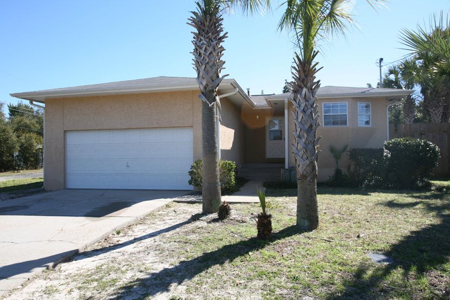 Brand new roof in October 2016! Nice three bedroom, two bath with large two car garage and back deck, privacy fenced backyard just two blocks to the beach! Home is on a dead end street with a living room with a stone fireplace and vaulted ceiling along with a very nice kitchen, dining area and breakfast bar. Master bedroom has bathroom, dressing area and separate vanity and toilet rooms. There is also a bonus room that can be used as an office. Outside has a wrap around deck and a hot/cold outdoor private shower. The two car garage offers a large workshop area. All measurements are approximate and if important, please measure to verify!