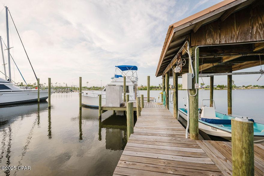 Welcome to 6905 Hugh Drive, where modern luxury meets relaxed coastal living. Completely remodeled from the studs up in 2023, this stunning 3-bedroom, 2-bathroom waterfront home sits on nearly 0.6 acres with 100 feet of deep saltwater frontage on Callaway Bayou, offering direct access to East Bay, Shell Island, and the Gulf beyond. Whether you're an avid boater or simply looking for peaceful waterfront living, this property delivers the ultimate Florida lifestyle.

Inside, you'll find a light-filled open floor plan with soaring 15-foot vaulted ceilings and luxury vinyl plank flooring throughout. The showstopping chef's kitchen features quartz countertops, stainless steel appliances, white shaker cabinetry, and an oversized center island, seamlessly flowing into the spacious living and dining areas--perfect for entertaining.

This home was rebuilt with quality and peace of mind in mind and features all new systems in 2023, including HVAC, hot water heater, electrical wiring, sheetrock, and more. The exterior is equally impressive with a beautiful metal copper roof that adds both durability and timeless character.

Step outside through French doors from the living room to a large covered back porch overlooking the bayou, ideal for relaxing or entertaining while enjoying breathtaking sunsets. The primary suite also features private French doors leading to its own deck, providing the perfect spot for morning coffee and serene waterfront views.

For boating enthusiasts, the new private dock includes power (50 amp and 110 amp), water, and a boat lift. The property also includes a new privacy fence with a double gate and additional parking with 11' clearance for RV or boat storage.

Offering peace, privacy, and endless waterfront adventure, this move-in-ready bayou-front home is just minutes from town while feeling like a private retreat.

Schedule your private showing today and experience the beauty of 6905 Hugh Drive for yourself.

All measurements are approximate. Information is believed to be accurate but should be verified by buyers if important.