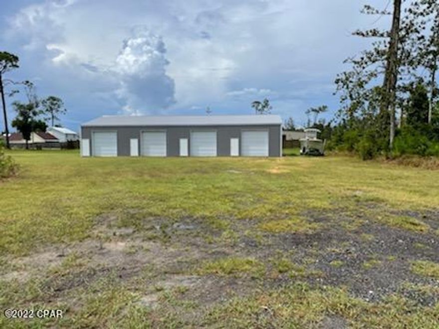 CURRENTLY UNDER CONTRACT, SELLER ACCEPTING BACKUP OFFERS Vacant lot with 4 bay shop (40x80, 3200 square feet!) and permitted house plans! 1.27 acres with brand new 500 foot deep well. Lots of space in unincorporated bay county but well located to Panama City Amenities