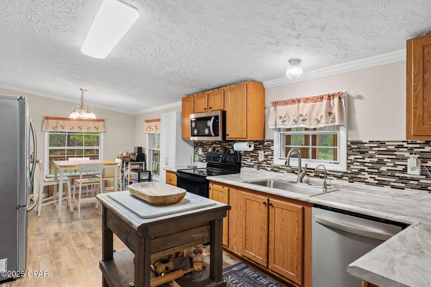 Nestled at the end of a quiet paved cul-de-sac, this spacious five-bedroom, three-bath home sits on a generous three-quarter-acre lot and perfectly combines modern updates with relaxed country living. The large kitchen has been completely remodeled with new countertops and LVP flooring, and the freshly painted interior offers plenty of space for family and guests. Major systems have been thoughtfully upgraded, including a new roof in 2019, new 200-amp electrical service in 2025, air conditioning replaced in July 2024, and a new water heater installed April 2025. Outdoor living shines here with two screened porches, a large brick patio with fire pit, and an above-ground swimming pool ideal for summer gatherings. A 12 × 36 workshop provides ample room for hobbies or storage, while handicap-accessible ramps offer easy entry into the home. The circular driveway adds convenience and curb appeal. Enjoy the best of country living just minutes from Bozeman High School and an easy commute to Panama City.

All Measurements are considered accurate but are approximate please verify if important.