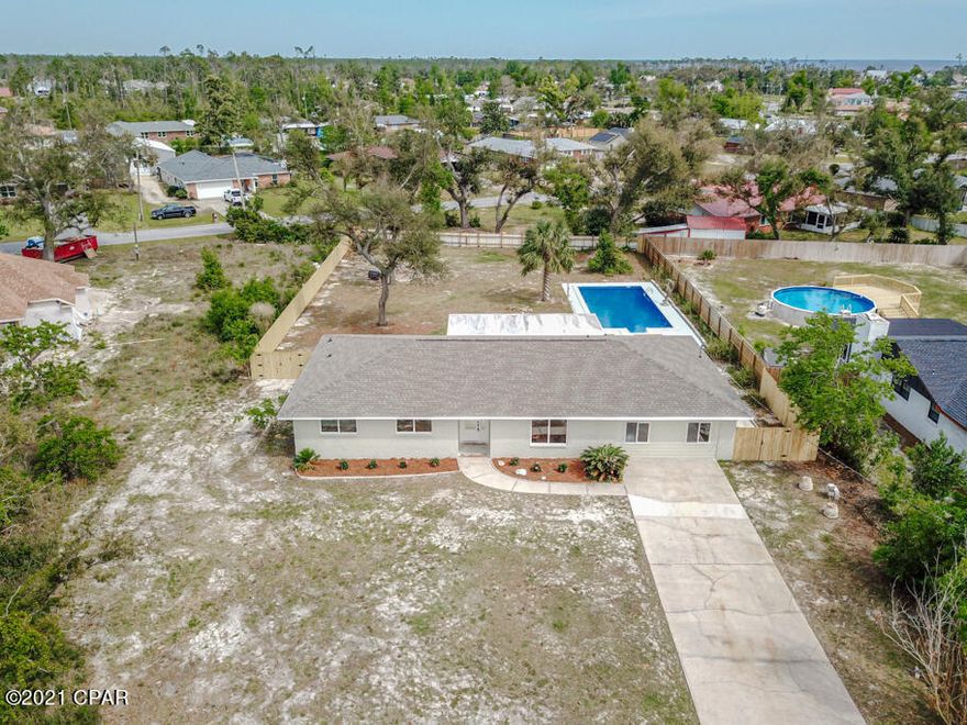 Absolutely beautiful home that has been completely renovated like new.  It is very convenient to Tyndall in a quiet neighborhood with character and charm.  This home is situated on a large nearly half acre lot with a fenced in backyard and oversized swimming pool.  There is a new deck great for grilling & lounging.  It also includes a spacious screened in back porch overlooking the yard.  The garage has been enclosed for a magnificent master suite set apart from the other 3 bedrooms and bathrooms. This one actually includes two master suites. The open layout of the living area makes it great for entertaining.  The light, neutral color schemes & decor are soothing.  The floors are luxury vinyl plank and tile for easy maintenance.   This one is ready to move into and enjoy.