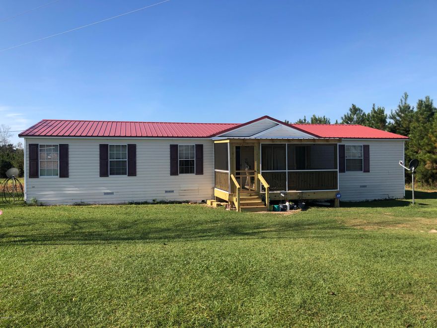Nice 2.8 acres with a 3/2 Double Wide with split bedroom design.  Fire place for cozy evenings, New Central heat and air unit. New roof in 2019, all this with paved road frontage excellent garden area. Near 231 and I-10 for convenience.  About 45 min to Panama City's 23rd street area.  So close to the beaches and excellent fishing in the area.  Make your appt. today. Seller has 2-5.5 acre tracts that can be purchased with this sale.