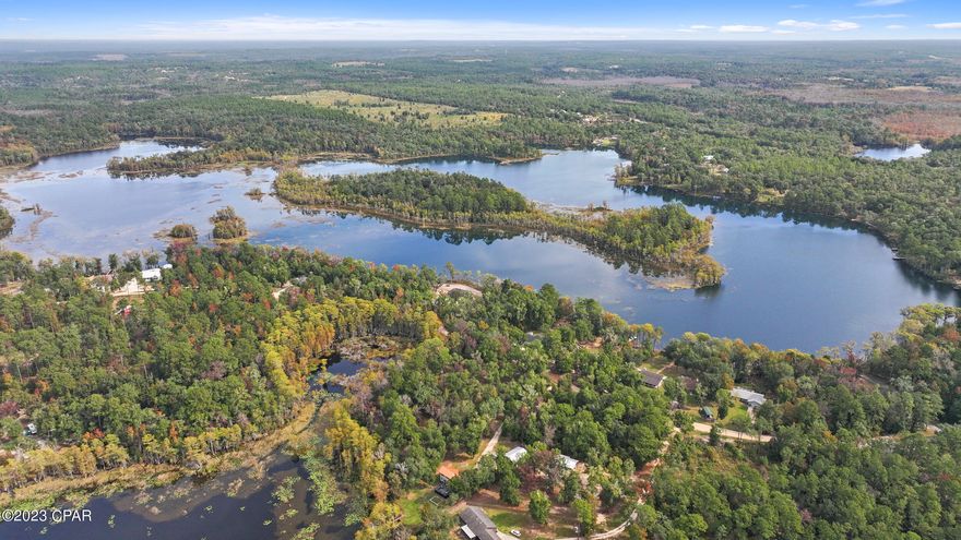 You have found your dream waterfront haven on Dunford Lake in the gated community of Paradise Lakes.  This parcel features frontage on Dunford Lake, presenting a 45' dock that beckons anglers to pursue Bass, Bluegill, and Crappie in this spring-fed oasis. Adding to the appeal, there is a 25'x40' metal building featuring a concrete floor, mini-split, insulation, a bath with a shower, and a separate area with a garage door for convenient storage.  An extra 10 x 12 storage building is included with this property, along with a well, septic system and a survey.

Additional property is available purchase on the opposite side of the road and is featured in a separate MLS listing.   

This property provides abundant space for crafting your private oasis or constructing your future home, catering to both the avid fisherman and nature enthusiast. Noteworthy is the currently inactive HOA, granting you the freedom and flexibility to bring your dreams to life.

Nestled within a secure, gated community, relish the tranquility and safety it affords. Just minutes away from the Northwest Florida Beaches International Airport, your journey to this waterfront sanctuary is effortlessly smooth. The vibrant Pier Park and the renowned World's Most Beautiful Beaches await only a short drive away, promising endless opportunities for entertainment, dining, and relaxation. Your waterfront paradise awaits - seize the boundless possibilities that this waterfront haven offers!
