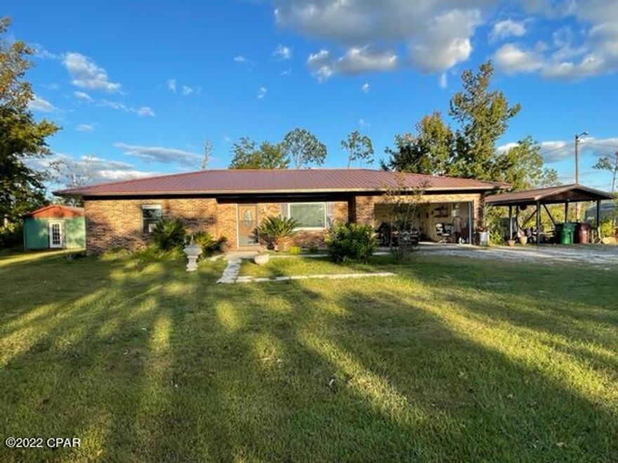 Well maintained brick house on two acres convenient to Deerpoint public boat ramp.  This house has two bedrooms plus a bonus room that has been used as a bedroom.  With this open floor plan, the kitchen overlooks the living room with a breakfast bar.  The exterior features a generous sized screened porch, a two-car garage, a detached carport and two detached yard buildings.  The property is fenced and includes a pond with a bridge.  Room dimensions and lot size is approximate. Please measure, if important.