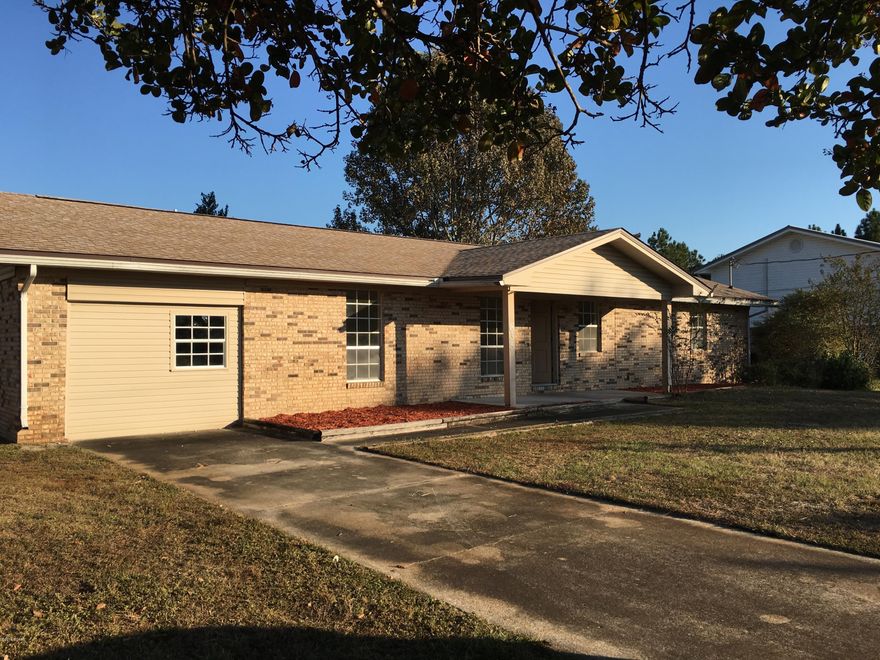 Spacious, solid brick home located in a quiet established neighborhood! This ranch style home is 1800+ sq ft and sits on a huge tree lined lot. Lots of family space includes a living room with a brick fireplace, a family room, a sun room, 4 bedrooms, 2 bathrooms and a large galley kitchen! Large neutral tile decks the floors throughout. The kitchen has lots of cabinets and hard surface counter space and offers gas cooking!  The ample laundry room is located inside. The awesome, partially fenced back yard offers plenty of room for kids to play and dogs to run or a pool to be installed.