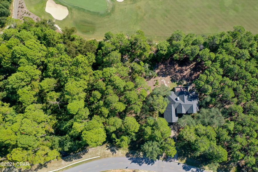 CURRENTLY UNDER CONTRACT, SELLER ACCEPTING BACKUP OFFERS. Here's the PERFECT opportunity to build your CUSTOM DREAM HOME! Located in the desirable, resort-like, and private community of Wild Heron, this vacant, wooded lot sits on the Greg Norman designed Shark's Tooth Golf Course. Not only does this property back up to the fairway, the lot next door is not buildable as it is owned by the HOA  - you'll get to enjoy the peace and quiet perk of having less neighbors! Not only will you get to enjoy the lovely community of Wild Heron, you'll have quick access to Lake Powell, the Gulf of Mexico, AND you'll be happily situated in between the heart of Panama City Beach and upscale 30A. Take advantage of the AWESOME community amenities: pool, hot tub, kiddie pool, fire pit, fitness center, tennis courts, and more! Don't miss out on this opportunity to make your home dreams come true! Call TODAY!