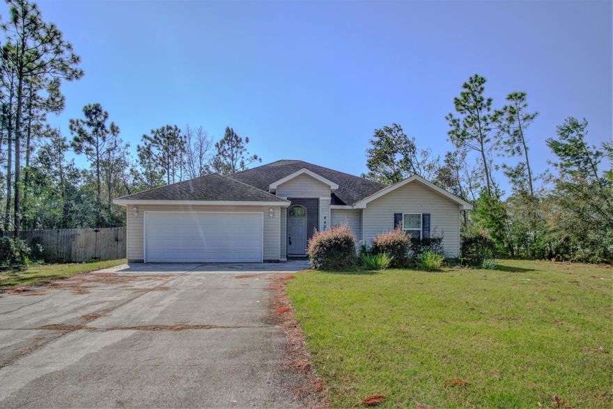 MOVE RIGHT IN! This 4 bedroom, 2 bath home is ready for occupancy - POST HURRICANE. The interior features an open floorplan with high ceilings, tile flooring throughout (carpet in bedrooms), an interior laundry room (washer and dryer convey), fresh paint throughout and a two car garage. The kitchen boasts stainless steel appliances, a breakfast bar and a large pantry. The master bedroom has a walk-in closet, can accommodate King Size furniture and has an adjoining bath with double vanity, garden tub and separate shower.  The exterior features a 102x328 lot, a covered back porch and an XL driveway for ample parking.  This home would be great for entertaining. Easy Maintenance Home and No Water/Sewer Bill.  Call today for your own private preview. Measurements approximate.