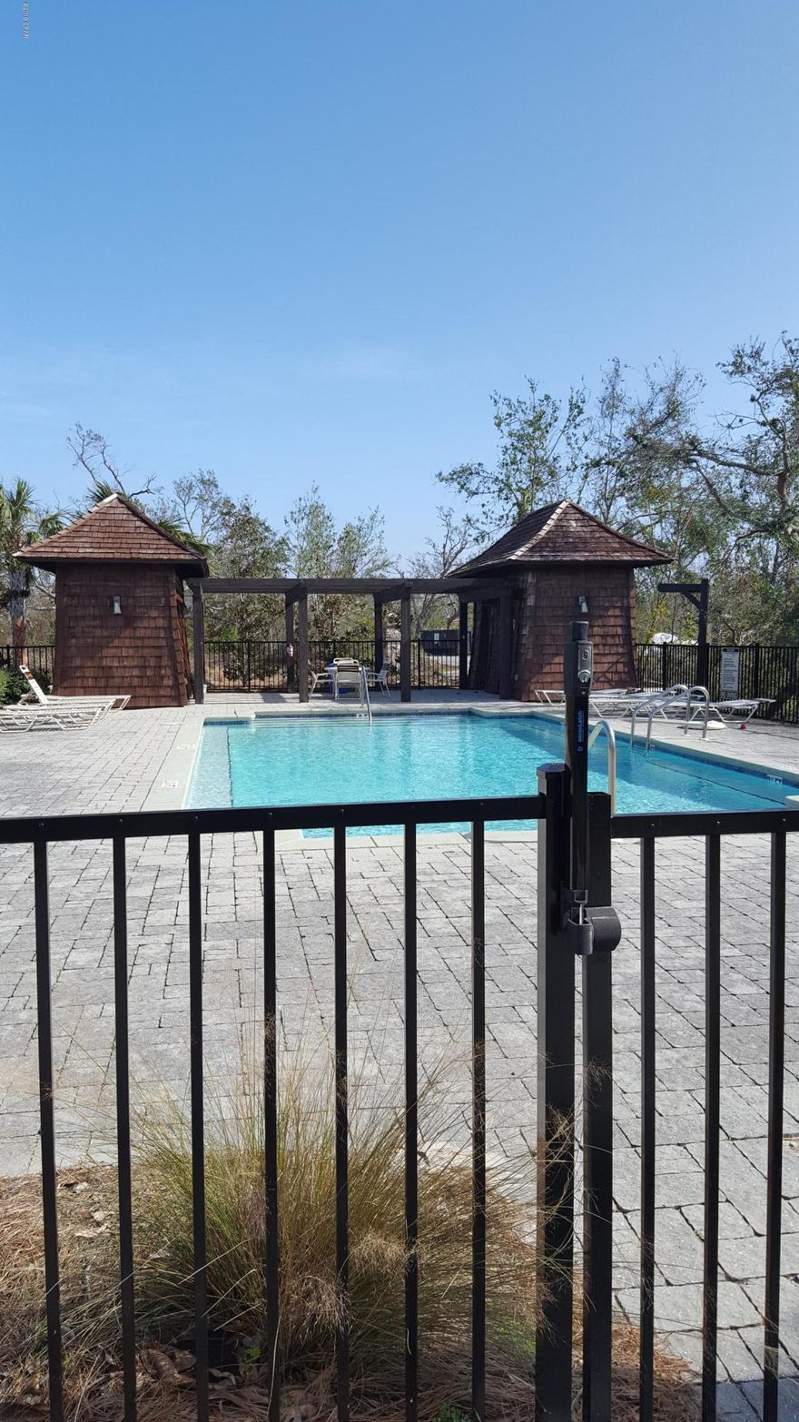 Large lot, one of the closest to the Bay in Sanctuary Beach. Sanctuary Beach is an exclusive gated community located close to golf, tennis, marinas, shopping and dining. This lot backs up to a protected wetland area affording superior privacy. The community has a beautiful gated pool with separate bathroom facilities for men and women and a BBQ area as well just a short walk from this property. The photos were taken in January 2019.