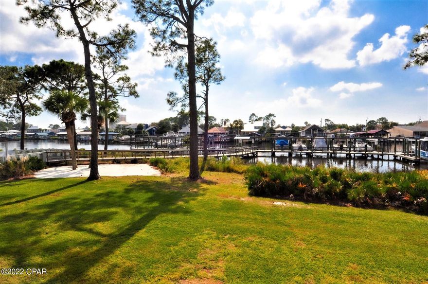 Currently under contract seller taking backups. Enjoy a beautiful view of Grand Lagoon from this first floor condo at Point Lagoon!  This is a 1 bedroom/1.5 bath unit that is being sold mostly furnished and move-in ready!  The interior features 16'' tile throughout, rich granite counter tops, stainless steel appliances, maple cabinetry, lots of closet/storage space, and a private balcony.  The unit comes with 1 assigned parking space in front of condo and there is plenty of visitors parking.  Point Lagoon has boat yard for boat storage and there is also a pool and a boat dock with slips.  Grand Lagoon has bay and gulf access and you can get there by boat within minutes!  All info approx. Buyer verify if important.