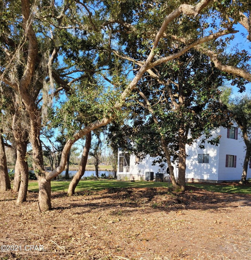 WATERFRONT! Country living with lots of shade trees, short drive to Lynn Haven and the beach. Newly remodeled 3 bedroom, 2 bath, bottom floor duplex with open floor plan and great view of the water.  Nice kitchen with granite countertops, new stainless steel appliances, LVP flooring throughout, Large bathrooms, laundry closet for stackable W/D, large screened porch facing the water, open patio. Lawn service provided. Property on Septic tank. 1 small pet under 20 lbs. $250 pet deposit?$50 monthly pet rent/$50 pet fee