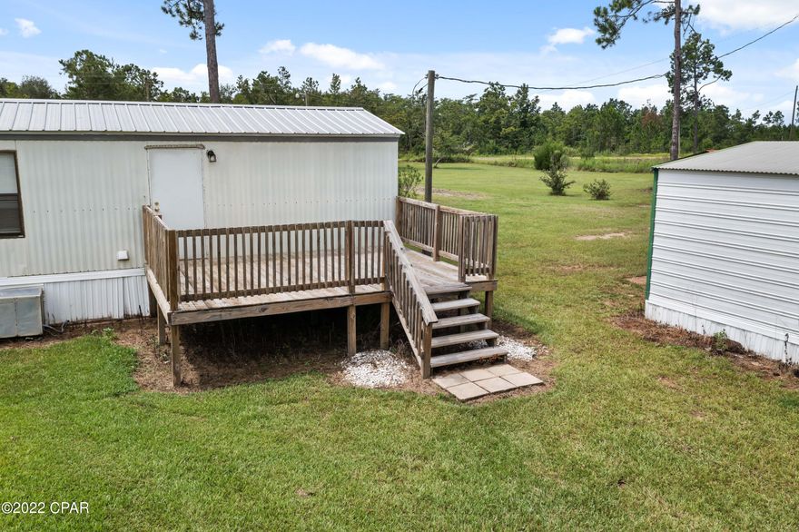 Stunning updated 2 bedroom 2 bath home on 5.95 acres. Extensive updates recently done with fresh paint, new kitchen cabinets and counter tops, new light fixtures, vinyl plank flooring, and so much more. There is a nice front porch and a 12x16  rear deck that overlooks landscaped back yard.  Has a two car detached carport and a 12x16 metal building with electricity.   Ideal for small family or couple just starting out.  Location is ideally located convenient to I-10 and Hwy 231 that goes north to Cottondale and south to Panama City on the coast.