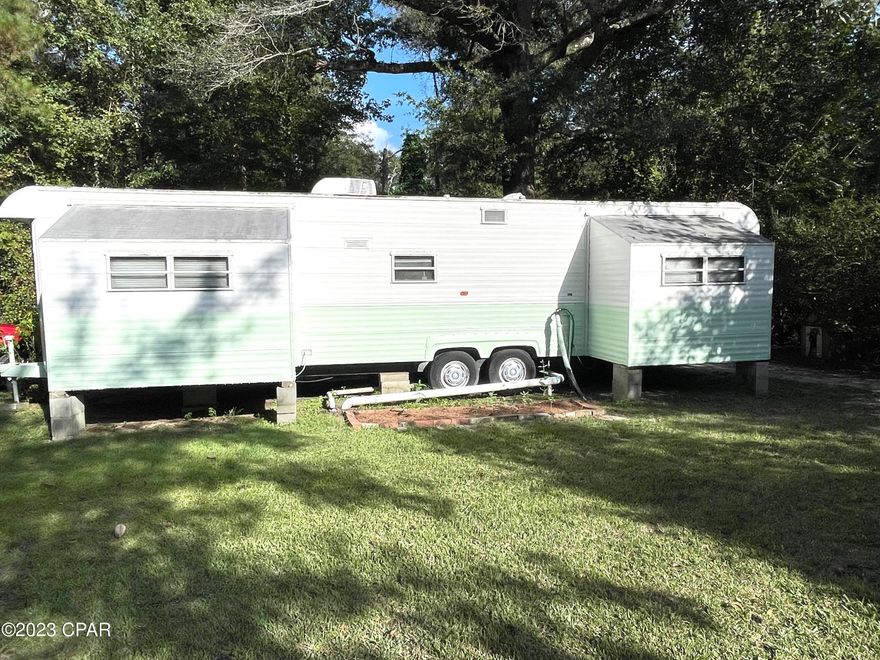 Creek Cabin Investment  fixer upper property!  
Fix up your dream home while living in your cute camper on a half an acre! The back of property is up next to County access to Wrights Creek. Peach trees, Blueberry bushes, Pear trees, Magnolia trees , Sugar cane and more are planted. Camper has been remodeled with nice flooring throughout and fresh paint. This property is a must see for a  weekend getaway or forever home. Schedule your showing soon.