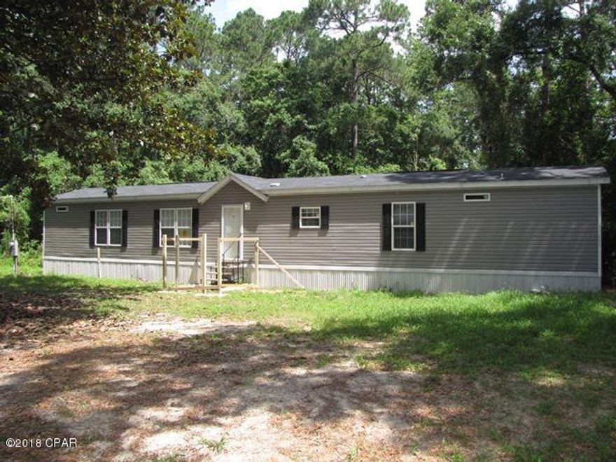 GREAT BUY on a 3 Bedroom 2 Bath Manufactured Home that has been completely renovated and is in like new condition. This is in the popular Bay Head area just 1 block from Beautiful Deer Point Lake. Lots of nice features to this home. Built-In Entertainment Center in Living Room, Big Island Work Station and Breakfast Bar in Kitchen, Separate Vanities in Master Bath, Garden Tub & Separate Shower in Master Bath, Big Walk-In Closet in Master, New Wood Plank look Vinyl Flooring in Living, Kitchen, and Baths, and New Carpet in Bedrooms, even New Window Treatments, Brand New AC Unit and Well Pump, all on a nicely shaded 1/2 Acre property. Possible Seller Financing depending upon review of Buyer's Credit Application. ACT NOW to take advantage of this GREAT OPPORTUNITY  !!