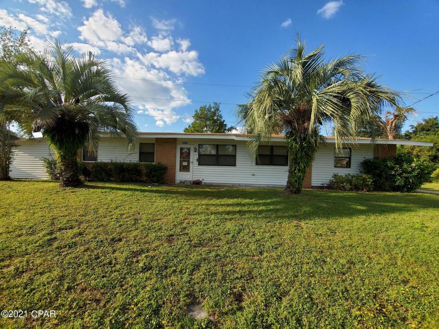 Currently under contract, sellers taking back up offers. Motivated sellers!!! Bring offers. You will love this 3 bedroom, 2 bath home. Conveniently located 1.8 miles to St. Andrews Marina and 7.9 miles to the white sandy beach. The covered 2 car carport provides shade and keeps you dry on those rainy days.  The separate owners retreat provides a nice place to relax and unwind from your busy day.  There are two citrus trees in the large fenced backyard.