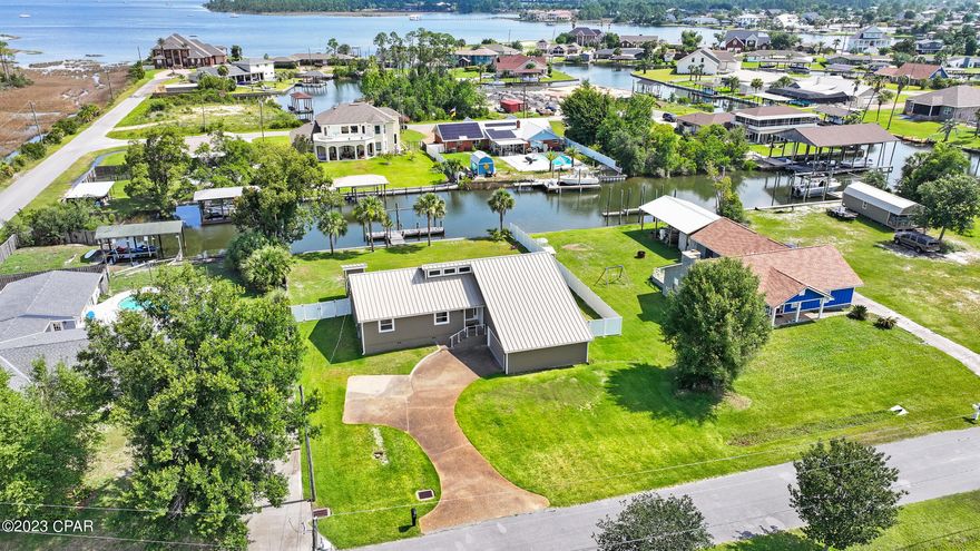 This stunning, fully renovated home offers a rare opportunity to own a waterfront oasis that seamlessly blends natural beauty with modern luxury.  The exterior of the home is encased in the upgraded zip board system with LP Smartside, hurricane rated doors and windows (lifetime warranty), and reinforced gable ends to allow you a safe and secure home and peace of mind.  
Step through the front door and prepare to be amazed by the exquisite craftsmanship and attention to detail throughout the home.  The living area features a ventless, propane fireplace for cozy winter evenings.  This space can be used as a den, home office, or an entertaining space.  
The gourmet kitchen is a culinary enthusiast's dream come true. It showcases top of the line stainless steel appliances that include a Blue Star gas range with 4 burners and a grill/griddle, Bosch dishwasher, GE Cafe refrigerator and a double wall oven with a convection/microwave on top.  The generous center island is perfect for preparing delicious meals and hosting gatherings.  Whether you're a seasoned chef or an occasional cook, this kitchen will inspire your culinary creativity.  
The 'open concept' family room layout creates a spacious and inviting atmosphere with two large double doors that frame the canal views, making it perfect for both everyday living and entertaining.
The master suite boasts lots of natural light with water views.  The master closet provides ample closet space to ensure your wardrobe is impeccably organized.  The bathroom has a step in shower and two separate vanities. A tankless water heater assures you that you'll never run out of hot water. 
Additional bedrooms provide privacy and comfort, accommodating family members or guests with style and grace.  
Beyond the interior, the outdoor living spaces are equally remarkable.  With an expansive back deck it is perfect for entertaining or marveling at the picturesque canal views.  The seawall was replaced in 2011 with upgraded deadman and stainless steel hardware to last decades.  There is a  dock and boat slip that can accommodate that largest of boats.  The sprawling backyard provides ample room for a pool of generous proportions, entertaining, and recreation.  
Located in a sought after neighborhood, this canal front renovated home offers an idyllic lifestyle.